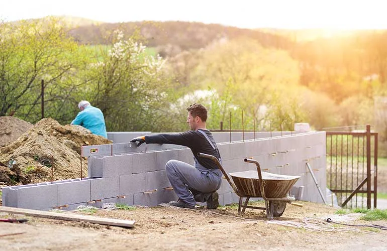 bricklayer-putting-down-another-row-of-bricks